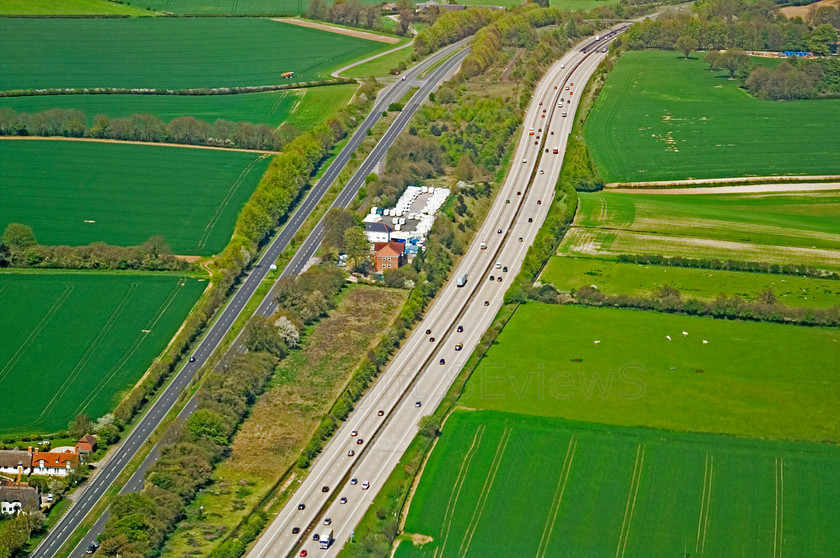 dual carriageway green fields Sussex 
 Aerial view of dual carriageway, green fields, Sussex 
 Keywords: Aerial view, green fields, dual carriageway, tractor tyre patterns