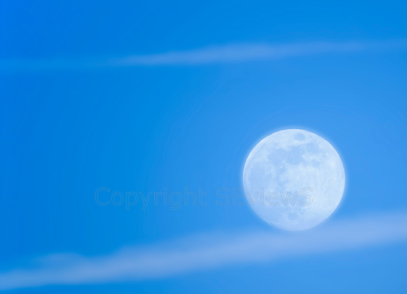 Rolling moonballl 
 Moon in full daylight ' rolling' down wispy cloud 
 Keywords: Sky, Moon, daylight, wispy cloud