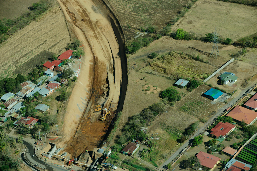 Channel dredging 2 
 Aerial view of Pacific Coast, Costa Rica 
 Keywords: Costa Rica, Pacific Coast, Aerial view, tin roof, excavator, drainage channel