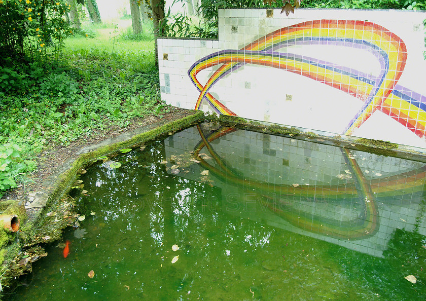 Arc en ciel ceramique 
 Ceramic tile rainbow reflected in pond 
 Keywords: Pond, Coulonges les Sablons, Eure et Loire, France