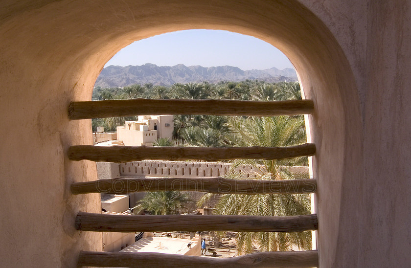 Nizwa Fort window view 
 Desert garden view through Nizwa Fort window 
 Keywords: Nizwa, Fort, Canon, Scenery, View