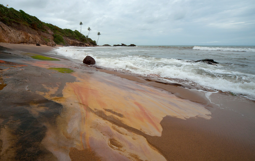 red sand and sandstone 
 Wet iron rich red sand and sandstone on Takoradi beach, Ghana, West Africa 
 Keywords: iron, sandstone, beach, atlantic ocean, waves, Takoradi, Ghana, West Africa