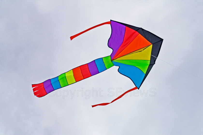 Rainbow kite 
 Rainbow coloured kite on grey cloud background 
 Keywords: kite, cloud, rainbow colours